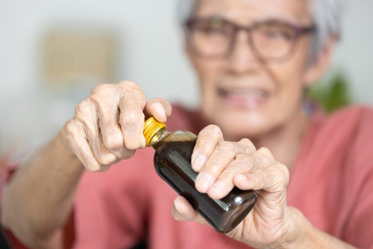 Asian,Senior,Woman,Hold,A,Bottle,Of,Liquid,Drug,old,Elderly